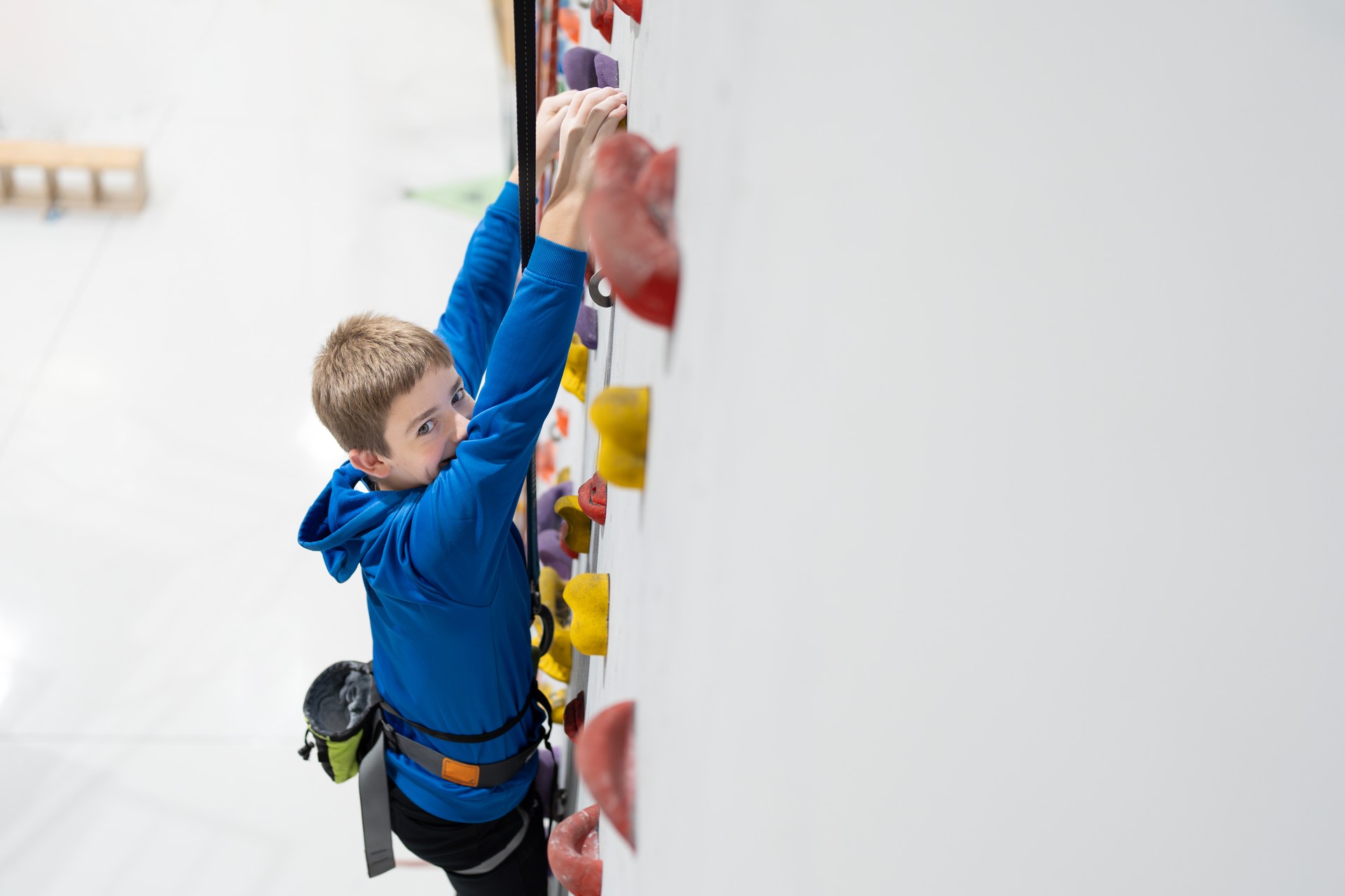 Preteen boy looking at camera while climbing